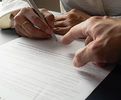 Woman signing paperwork